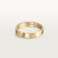 Gold Cartier ring on a light beige background