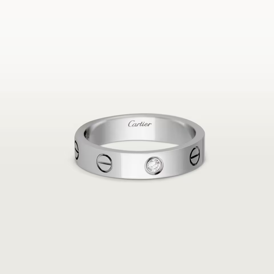 Cartier ring with diamond on a white background