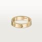 Gold Cartier ring with a diamond on a light gray background
