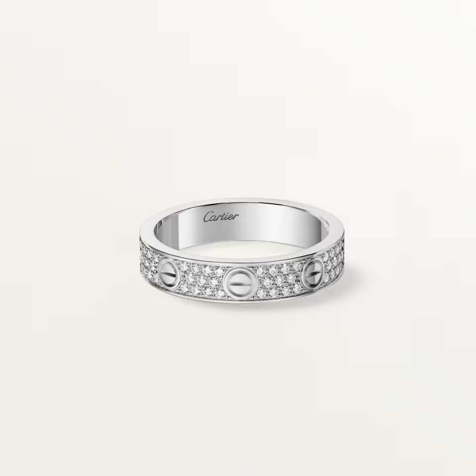 Silver Cartier ring with diamonds on a light beige background