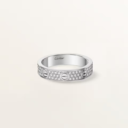 Silver Cartier ring with diamonds on a light beige background