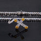 Jewelry with yellow and clear stones on a reflective surface