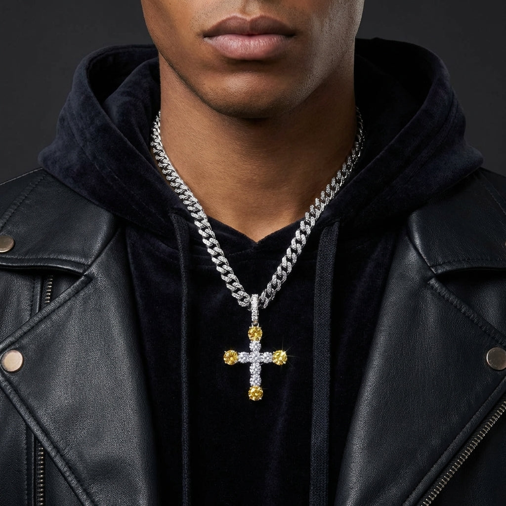 Man wearing a black leather jacket and a necklace with a cross pendant on a dark background