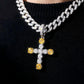 Necklace with a cross pendant featuring yellow and clear gemstones on a black background