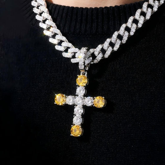 Necklace with a cross pendant featuring yellow and clear gemstones on a black background