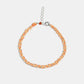 Bracelet with orange and silver braided design on a white background