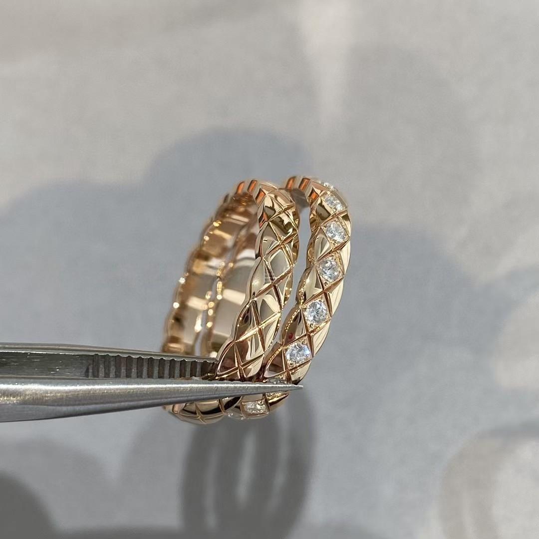 Rose gold ring with diamond accents held by tweezers on a neutral background