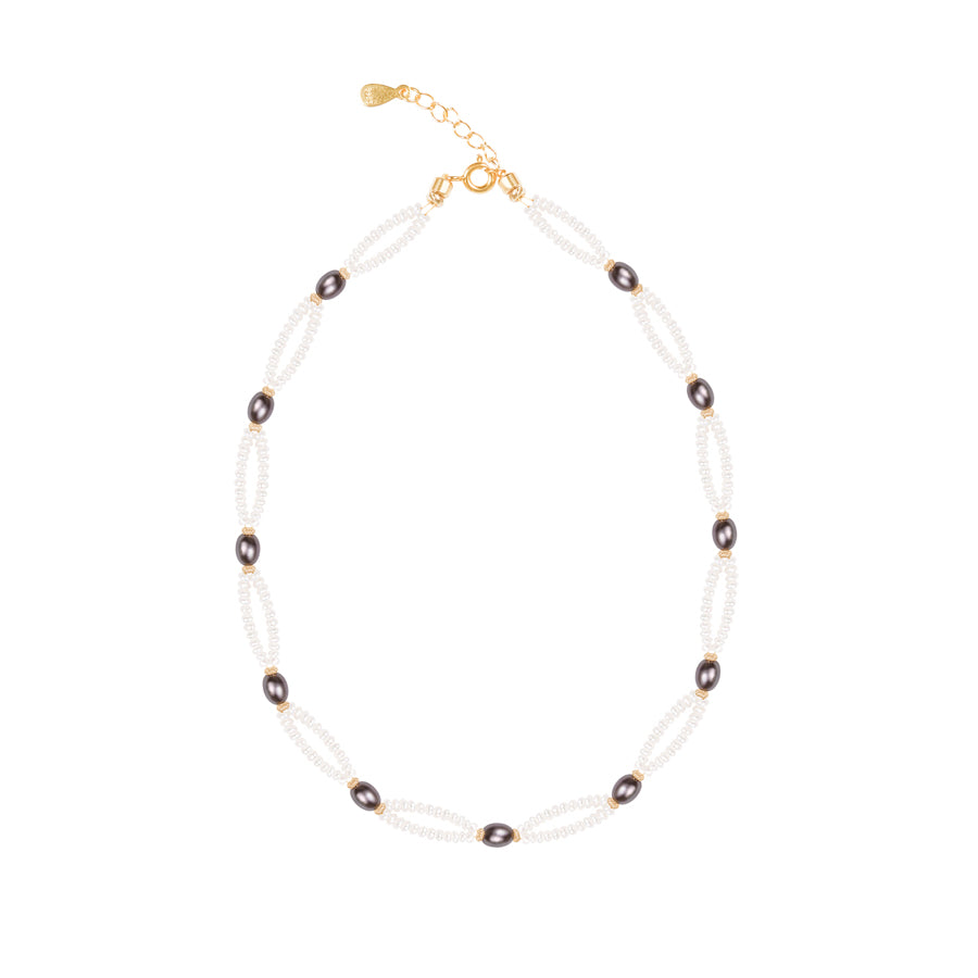 Necklace with pearls and dark beads on a white background