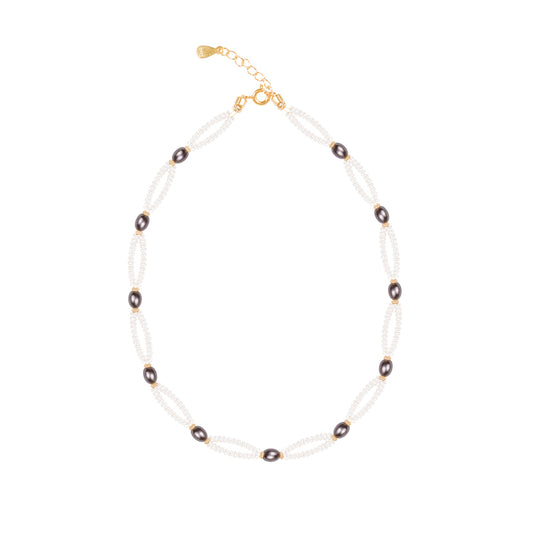 Necklace with pearls and dark beads on a white background