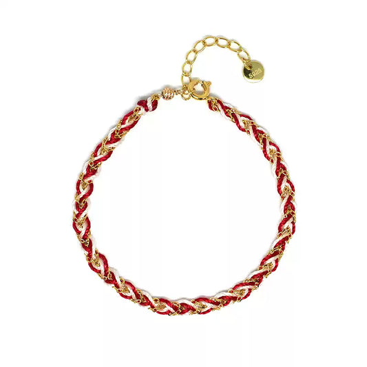Bracelet with red and gold braided design on a white background