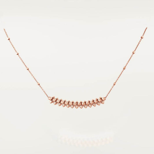 Clash de Cartier pendantRose gold necklace on a light gray background