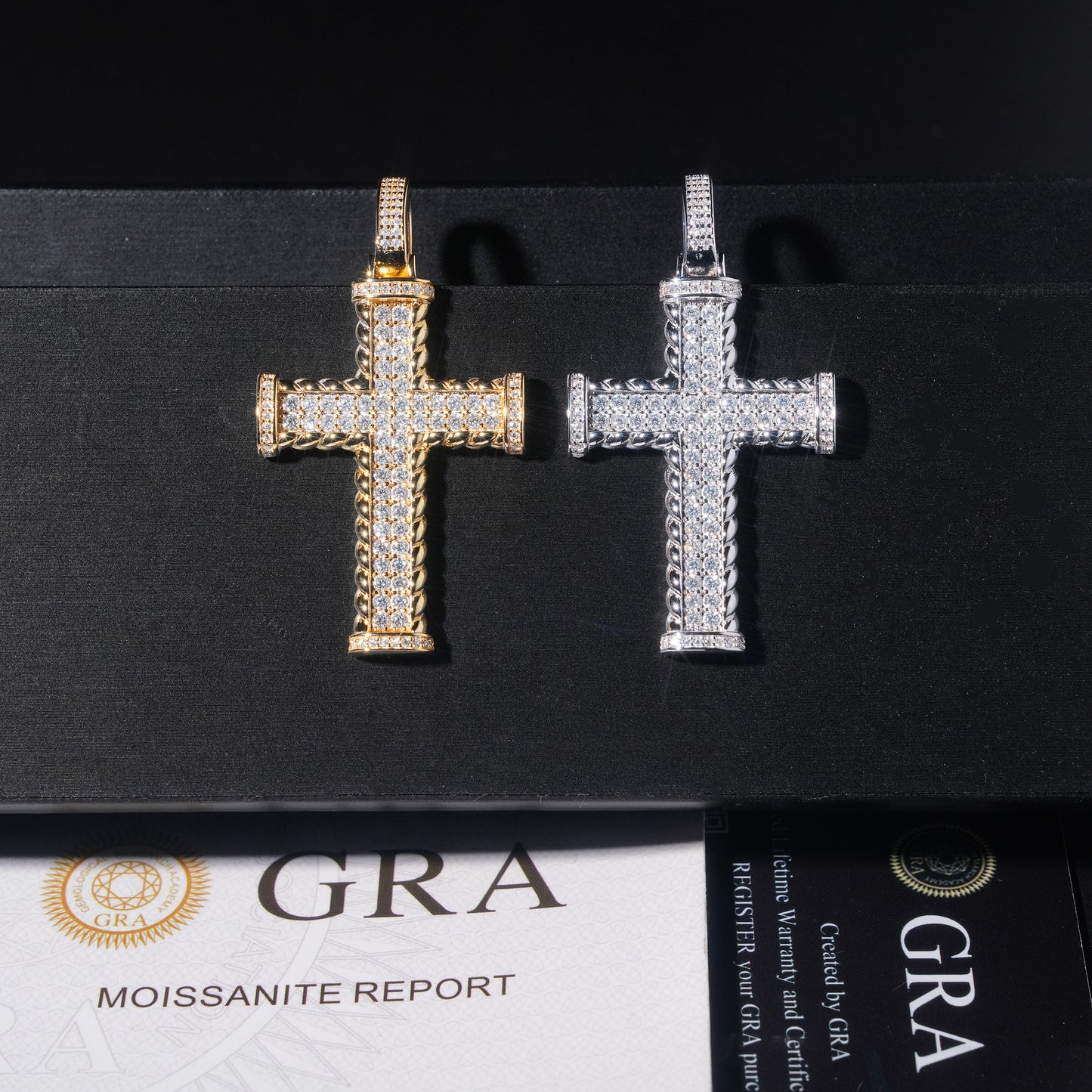 Gold and silver cross pendants on a black background with GRA certification below.