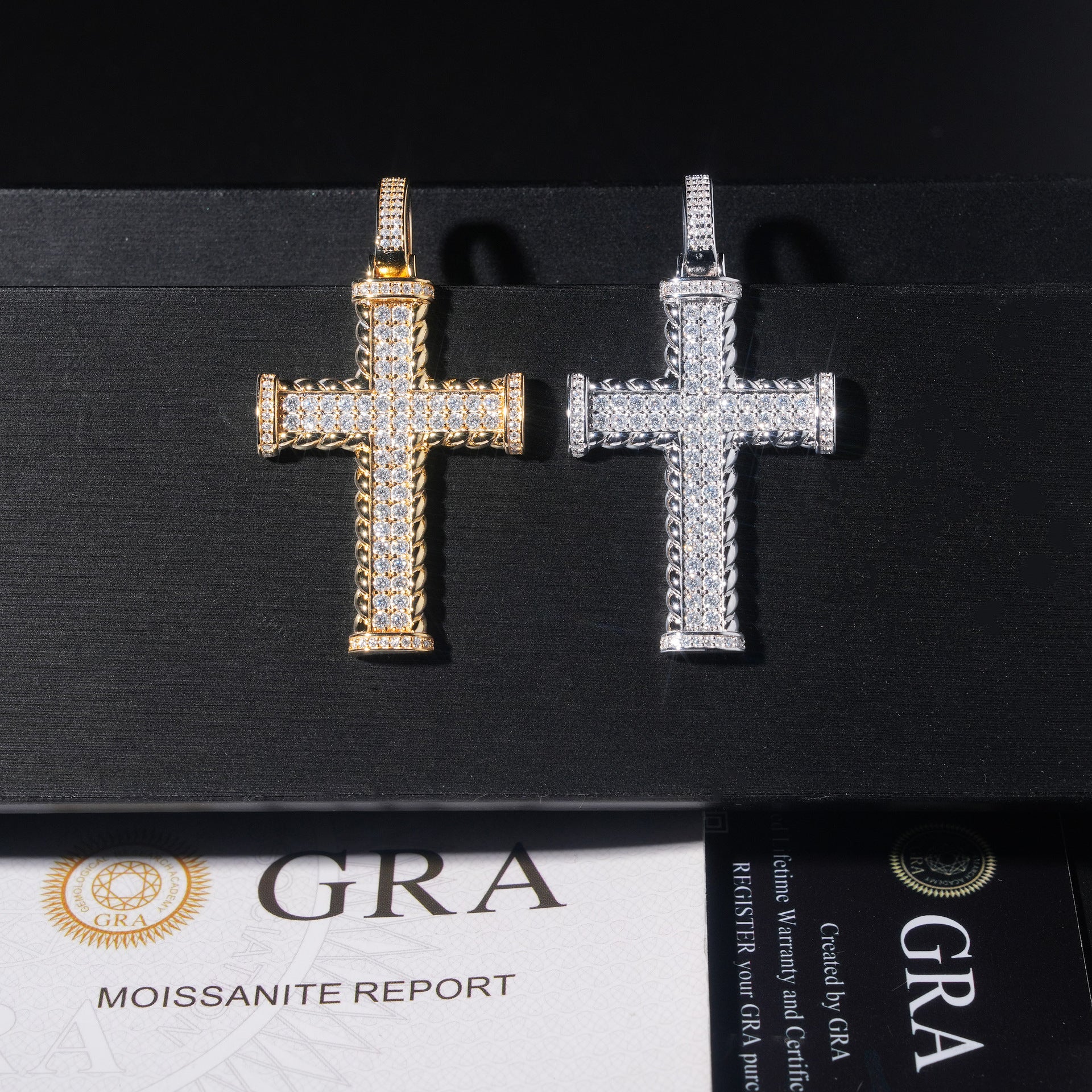 Gold and silver cross pendants on a black background with GRA certification below.