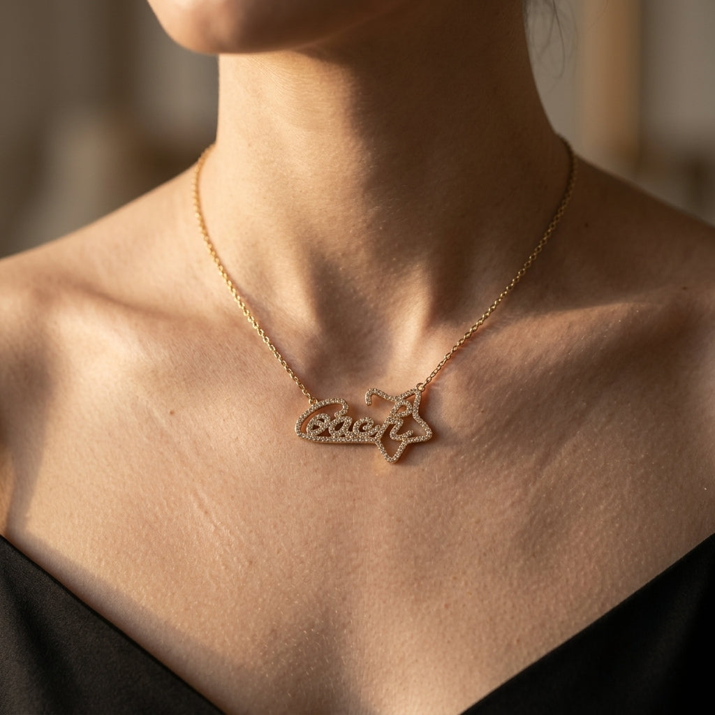 A close-up of a model wearing a delicate gold chain necklace with a custom name pendant spelling 'Evelyn' in script, set against a warm, softly blurred background.
