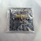 A Coach New York logo keychain in a gold-tone horse-drawn carriage design, packaged inside a clear bubble bag with a black branded backing card on a white background.