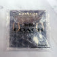 A Coach New York logo card inside a clear bubble wrap polybag, with gold-tone logo lettering and a horse-and-carriage emblem visible through the plastic.