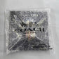 A Coach New York logo printed on a black garment inside a clear plastic protective polybag, photographed against a light gray background.
