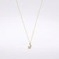 A delicate gold chain necklace featuring a crescent moon and star pendant adorned with small clear stones, set against a clean white background.