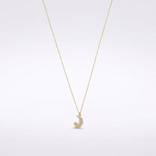 A delicate gold chain necklace featuring a crescent moon and star pendant adorned with small clear stones, set against a clean white background.