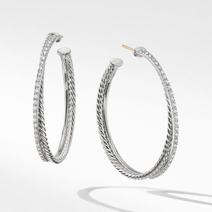 Pair of silver hoop earrings on a light gray background