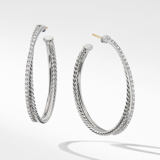 Pair of silver hoop earrings on a light gray background