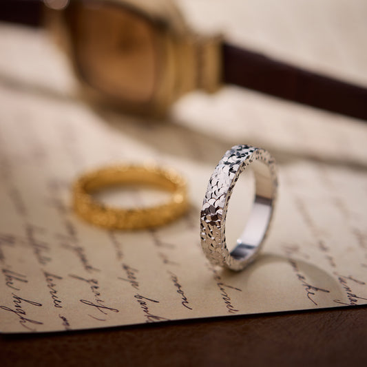 Silver ring on a piece of paper with a blurred background