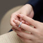 Close-up of a hand wearing a ring with a blurred background