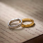 Two gold and silver rings on an old letter.