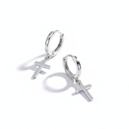 Silver hoop earrings with cross charms on a white background