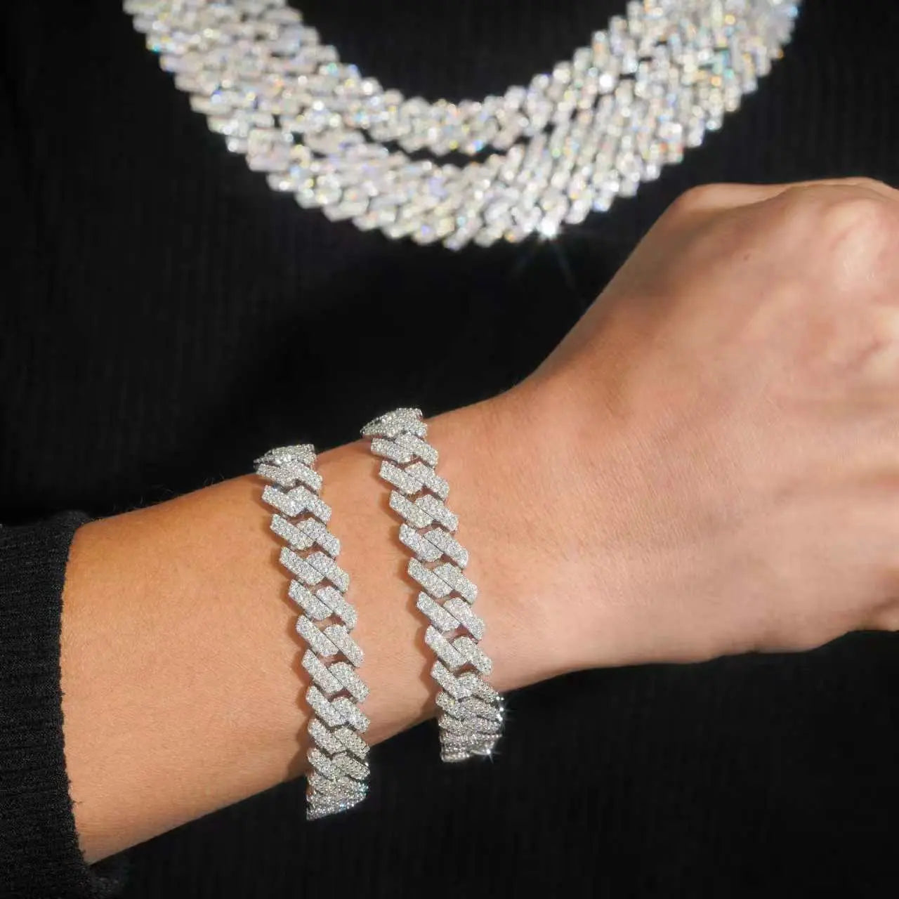 Cuban Moissanite Chain  13MMSilver bracelet on a wrist with a necklace in the background