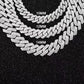 Three diamond-encrusted chains of different widths on a black background