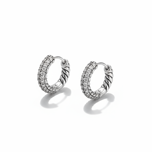 Pair of silver hoop earrings with embedded stones on a white background