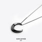Crescent moon necklace on a white background with 'Dark Anthem' branding.