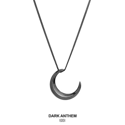Crescent moon-shaped pendant necklace on a white background with 'Dark Anthem' branding.