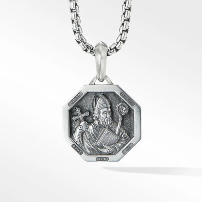 Silver pendant necklace with a detailed design on a white background