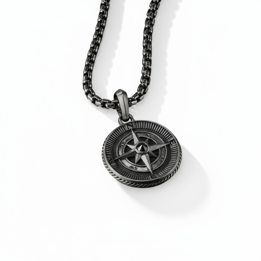 Black compass pendant necklace on a white background