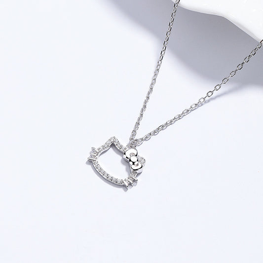  Kitten pendant on soft pastel background. Alt: “Diamond Cat Necklace – Sterling Silver CZ Bow Kitten Pendant.”