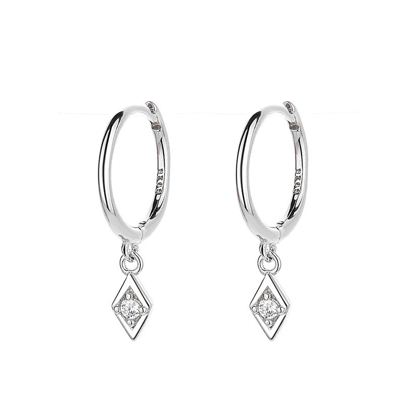 Earrings on soft cream background. Alt: “Diamond Pendant Hoop Earrings – Delicate Gold Drop Jewelry.”