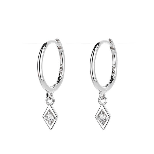 Earrings on soft cream background. Alt: “Diamond Pendant Hoop Earrings – Delicate Gold Drop Jewelry.”