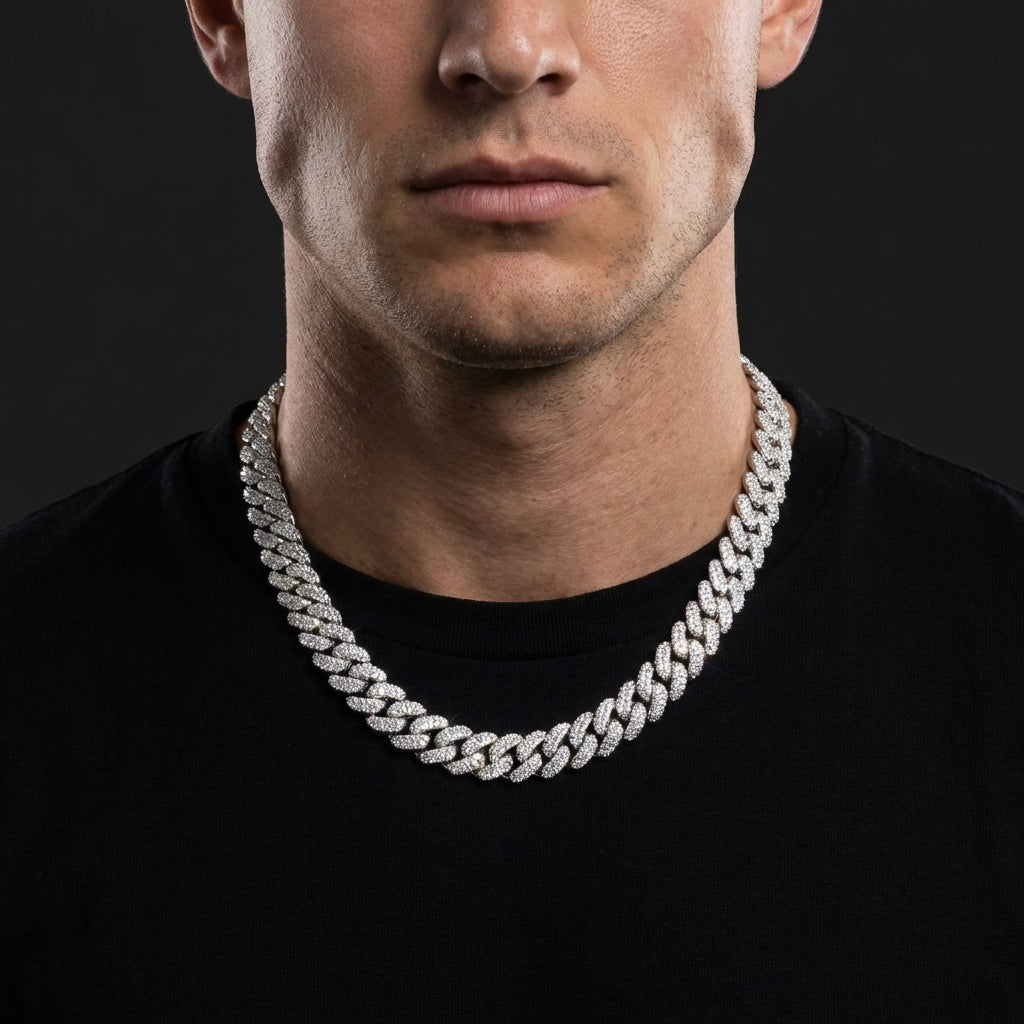 Man in a hoodie and sneakers, the double row iced Cuban chain resting prominently on the chest — extra wide, extra bold, next-level hip-hop luxury.