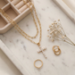 Top-down flat lay of the necklace on a white marble tray, styled with earrings, ring, dried flowers and a velvet jewelry box, soft warm tones, balanced composition, elegant e-commerce aesthetic.