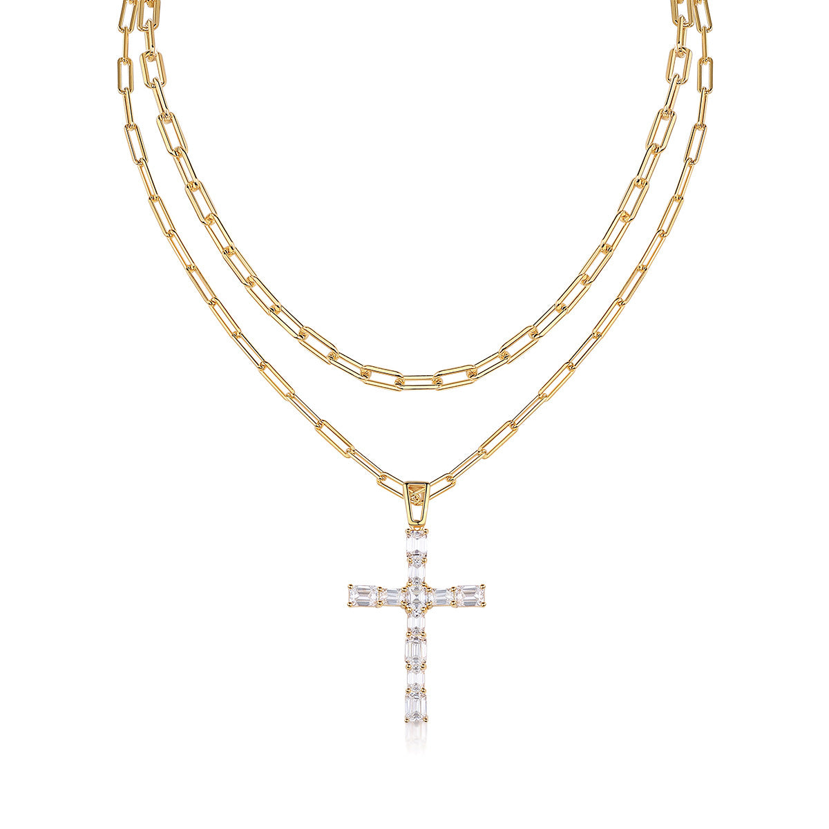 Clean white background — the emerald cut moissanite cross pendant layered with a delicate solo chain on a bust form. The cross catches light, showing the distinctive step-cut facets and brilliant sparkle. Chains drape gracefully without tangling.