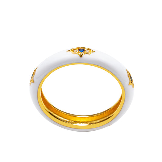 Ring with gold band and white ceramic design on a white background