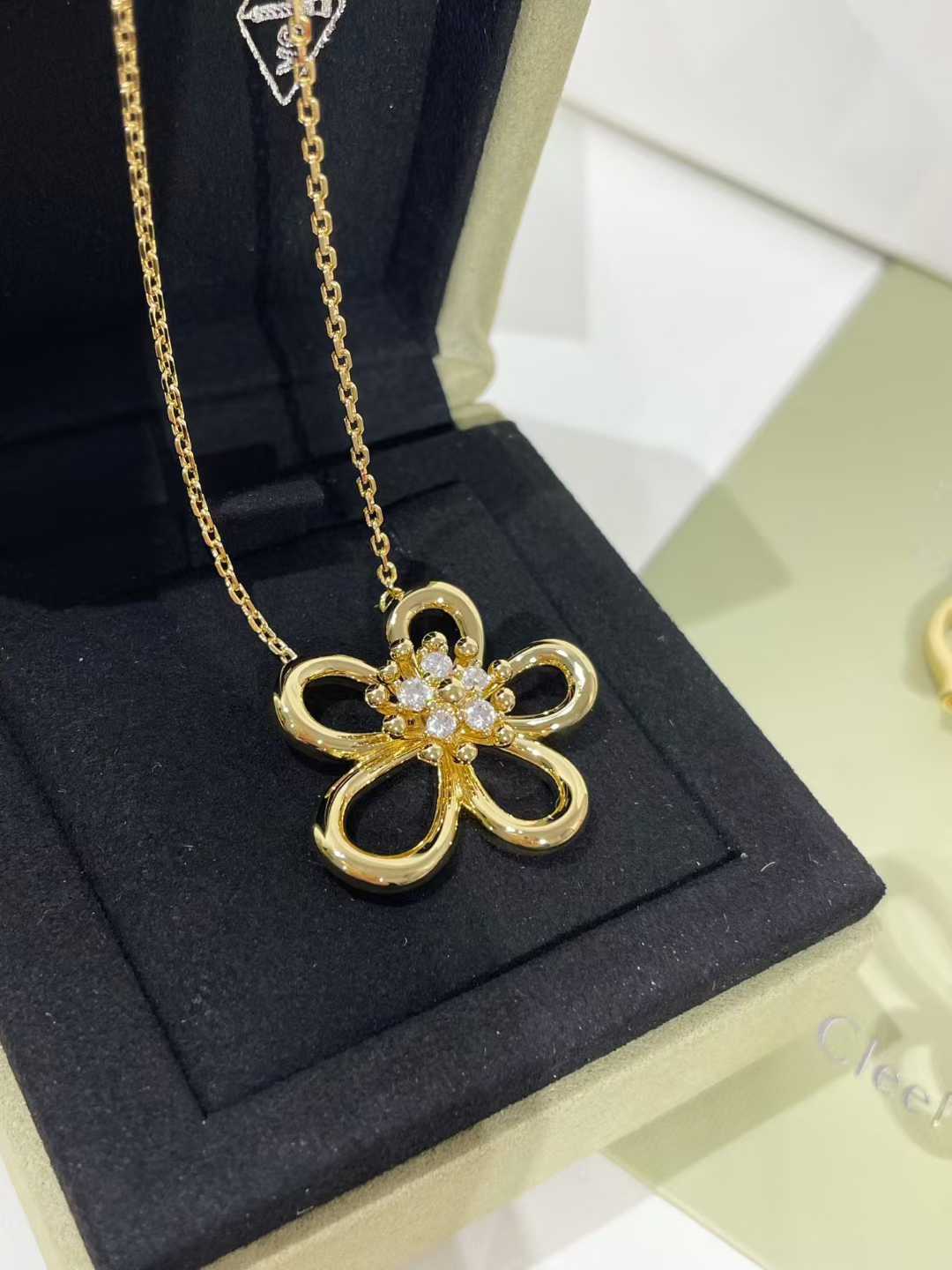 “Floral lace inspired pendant with cubic zirconia on white background”