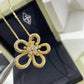 “Flowerlace style gold plated pendant necklace flat lay”