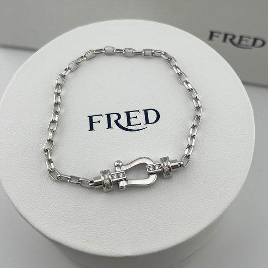 Silver bracelet on a white display with 'FRED' branding