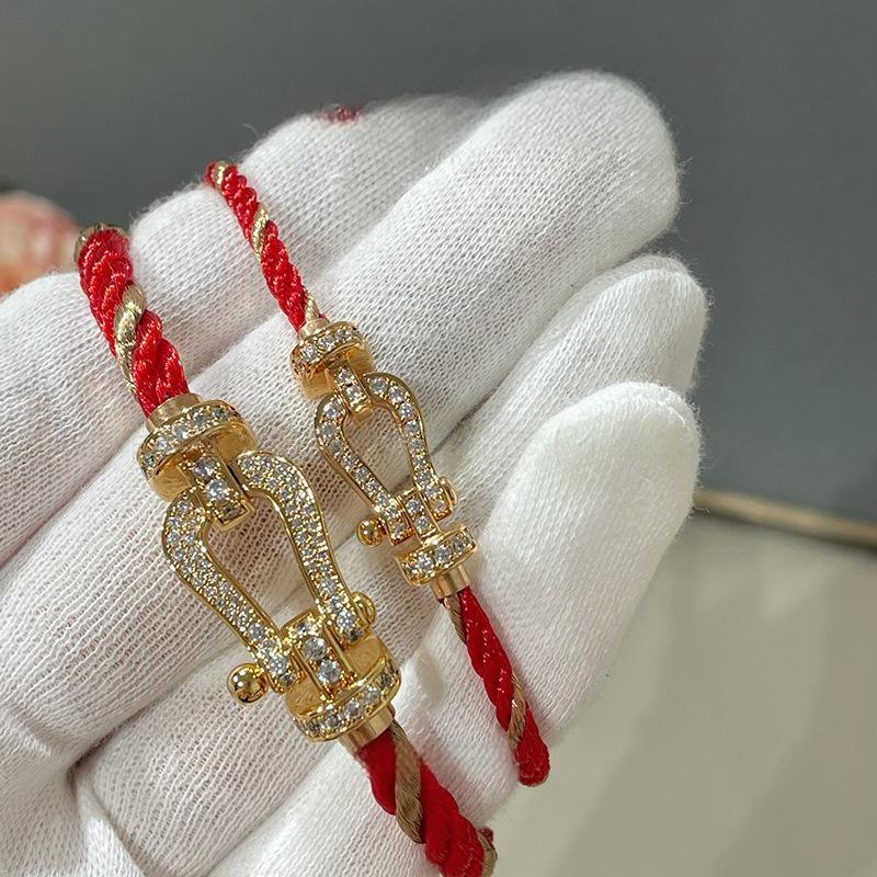 Force 10 bracelet 18k yellow gold and diamonds on a white gloved hand with a neutral background