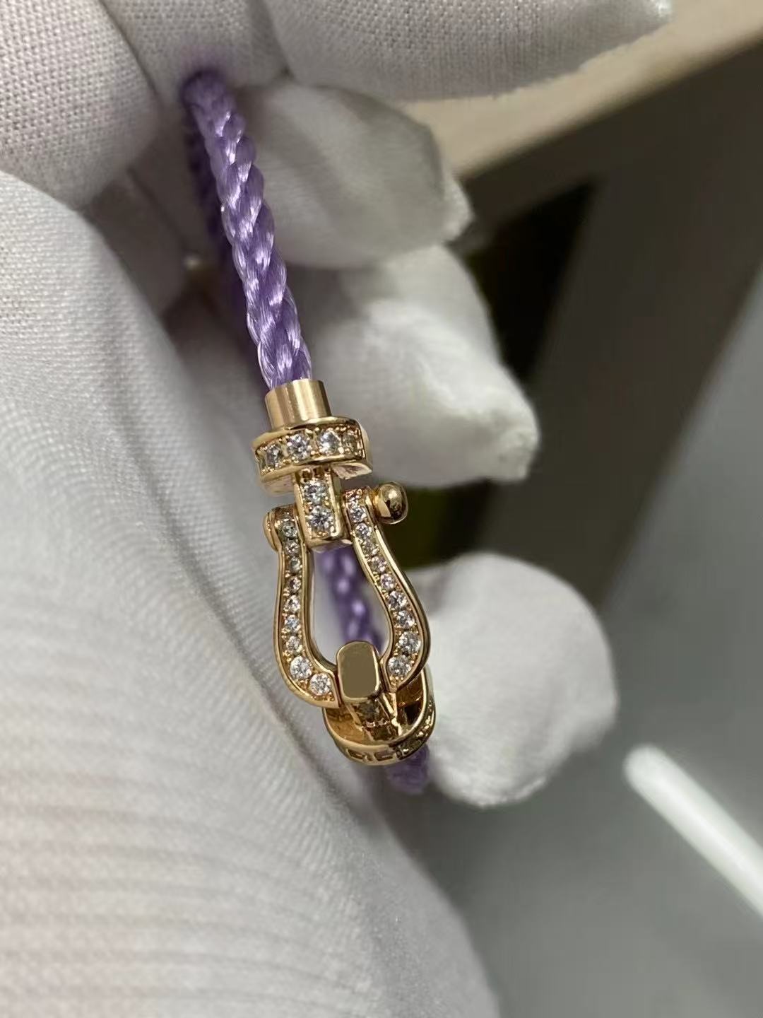 Force 10 bracelet 18k yellow gold and diamonds medium modelcord with a gold and crystal clasp on a white background