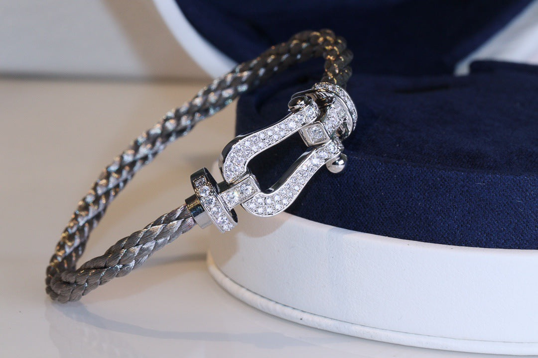 Force 10 bracelet 18k yellow gold and diamonds medium modelwith diamond accents on a white and blue background