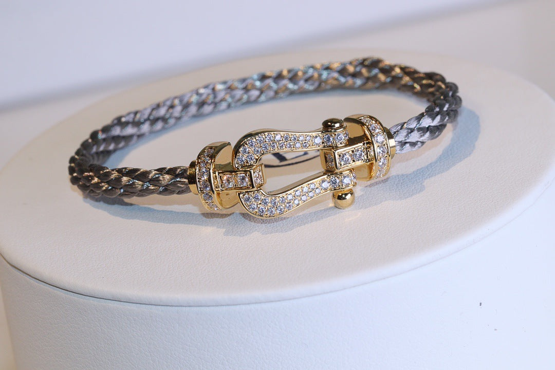 Force 10 bracelet 18k yellow gold and diamonds medium modelgold clasp and braided design on a white surface